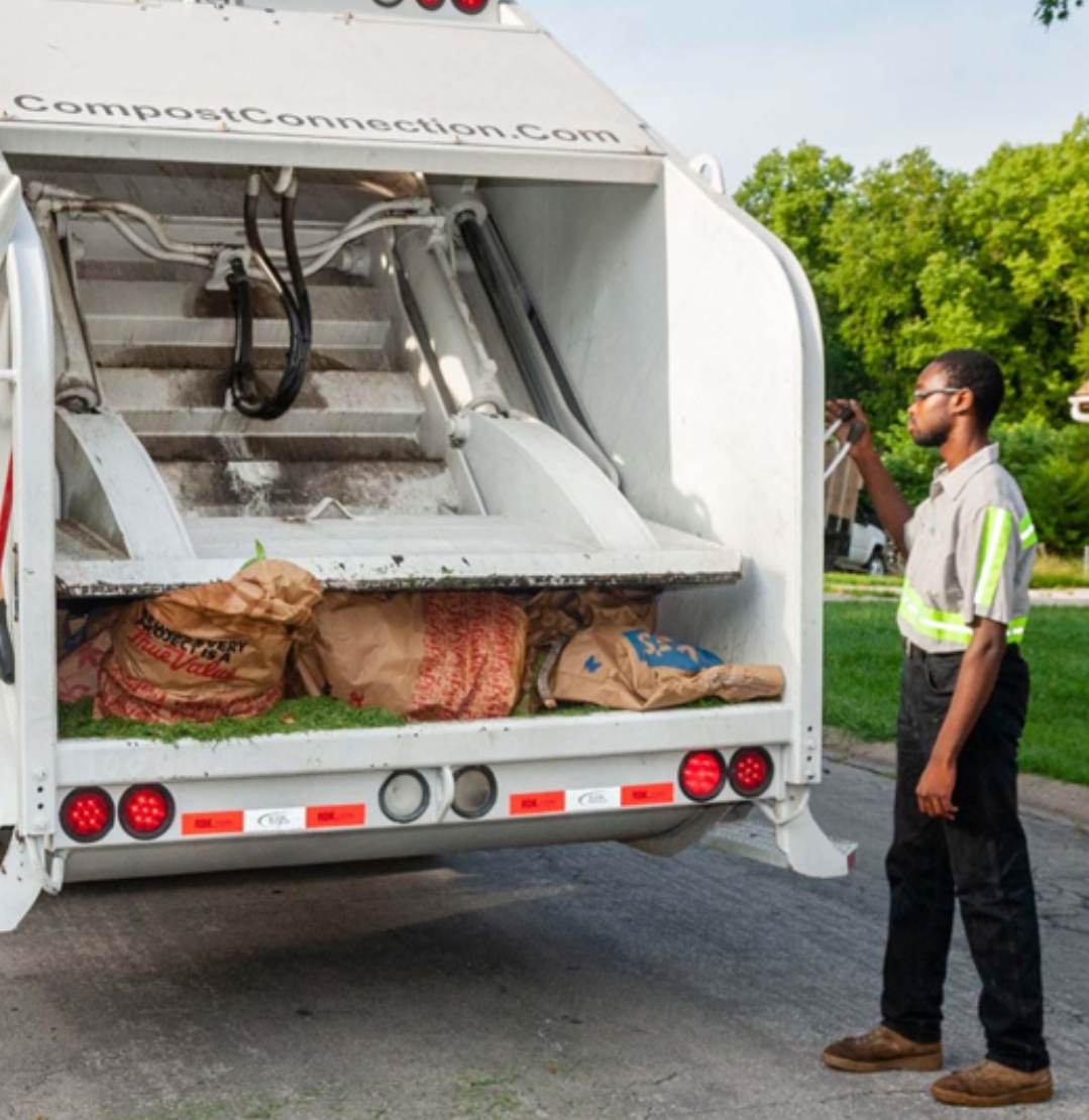 compost connection staff putting the yard waste on the truck