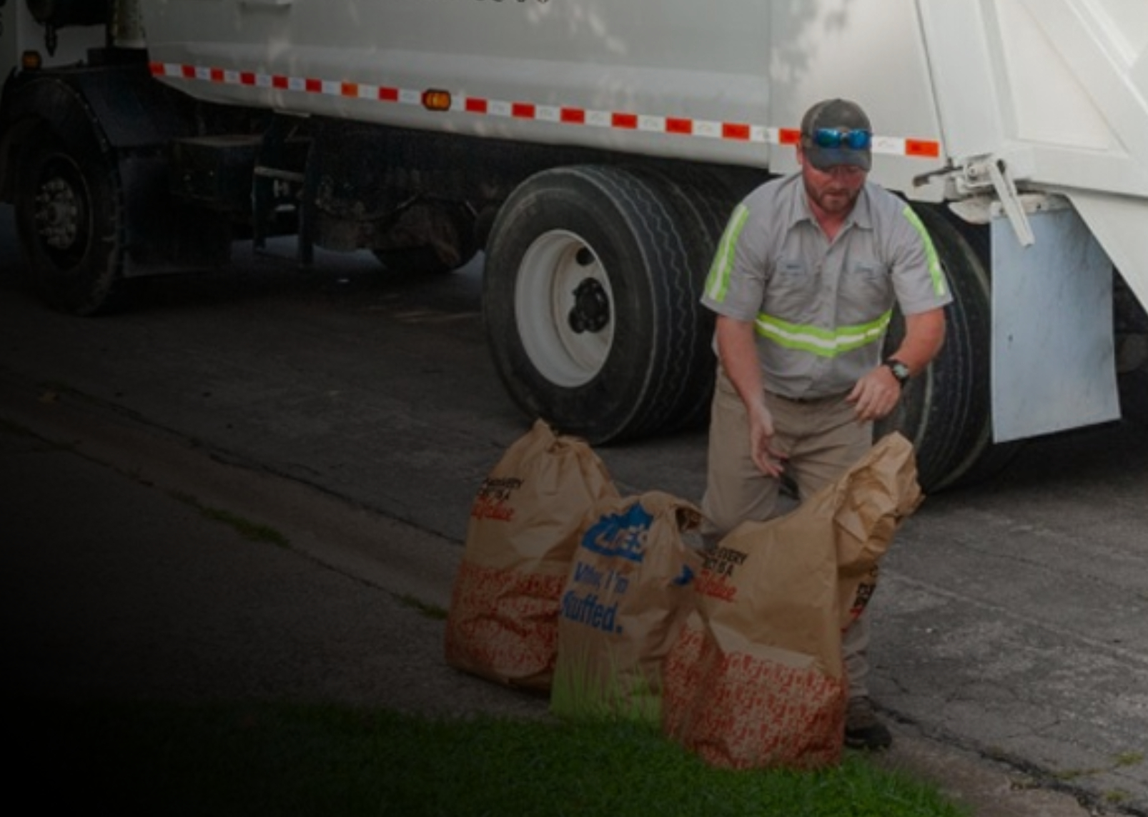 https://compostconnection.com/wp-content/uploads/2023/06/yard-waste-in-front-of-house-collected-by-compost-connection.jpg